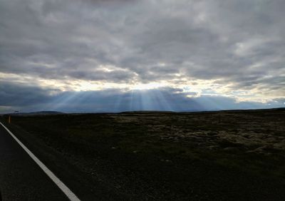 Road by landscape against sky