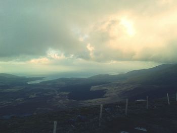 Scenic view of mountains against cloudy sky