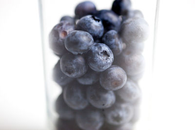 Close-up of blueberries against white background