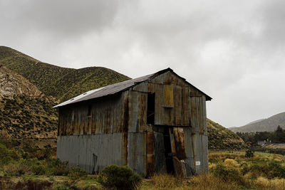 Old building on field against sky