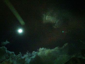 Low angle view of moon in sky at night