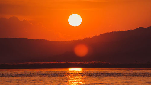 Scenic view of sea against romantic sky at sunset