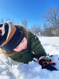 Low angle view of boy standing on snow
