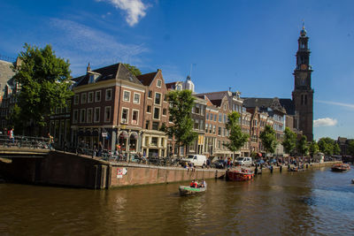 Boats in river with buildings in background