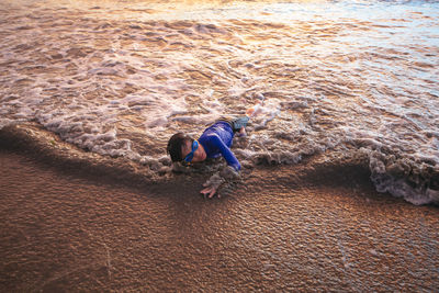 Boy playing at sea