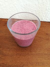 High angle view of pink juice on table