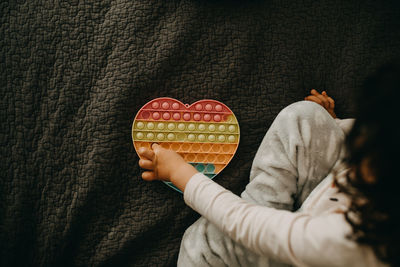 Child playing with pop it fidget toy