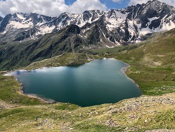 Scenic view of lake and snowcapped mountains against sky