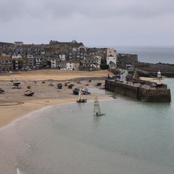 High angle view of pier and beach by buildings 