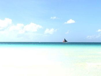 Sailboat in sea against sky