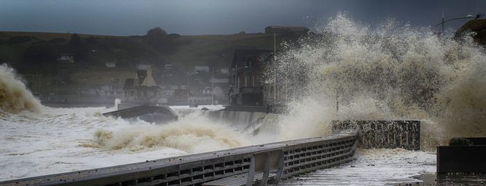 Panoramic shot of waves breaking against the sky