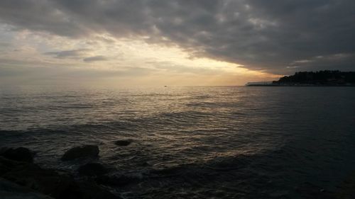 Scenic view of sea against cloudy sky