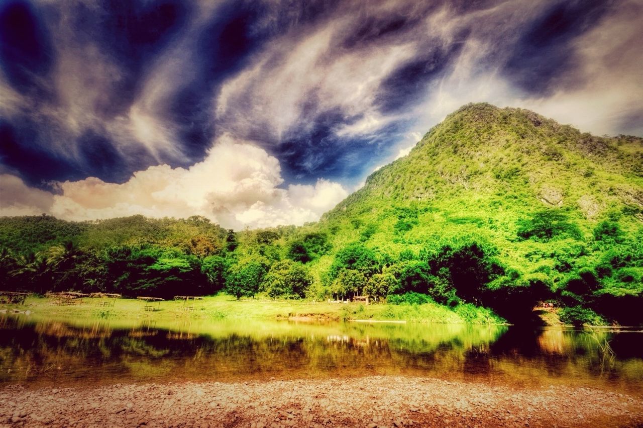 sky, tranquil scene, mountain, tranquility, scenics, landscape, cloud - sky, beauty in nature, tree, cloudy, nature, green color, grass, cloud, non-urban scene, growth, mountain range, idyllic, hill, plant