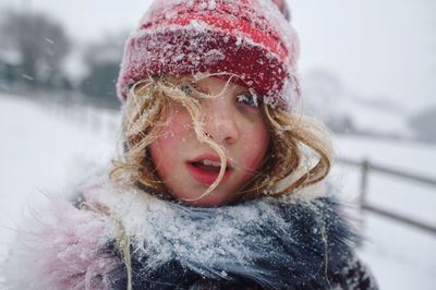 Close-up portrait of a girl in snow