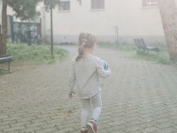 Rear view of woman walking on street
