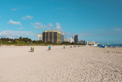 People at beach against sky