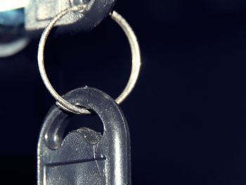 Close-up of metal chain against black background