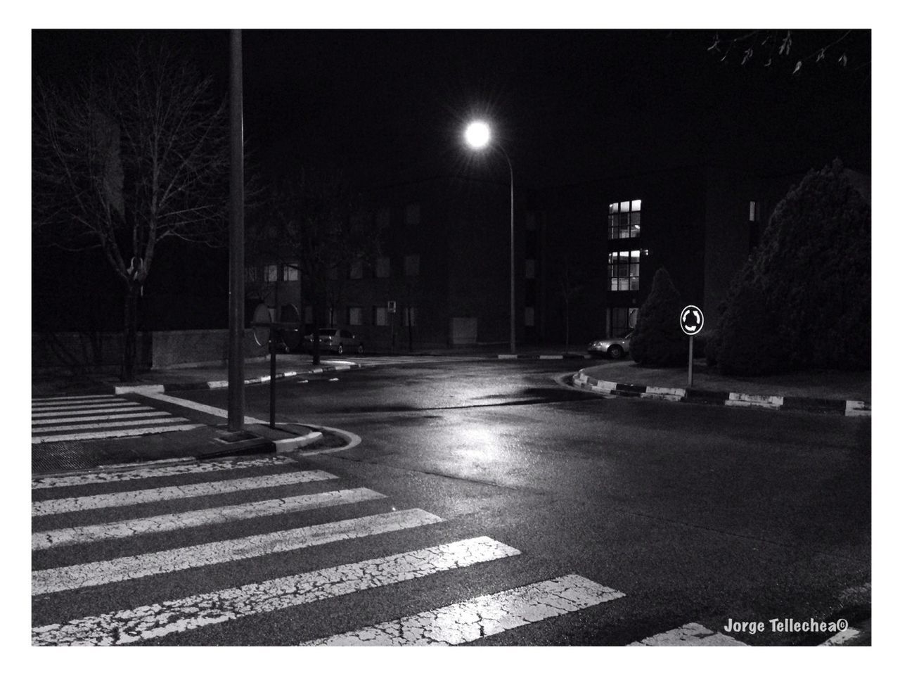 night, illuminated, street light, the way forward, building exterior, street, architecture, built structure, transportation, road, transfer print, city, lighting equipment, empty, road marking, auto post production filter, sidewalk, car, outdoors, sky