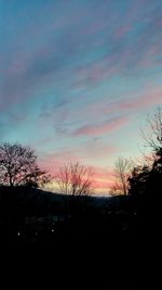 Silhouette trees against sky during sunset