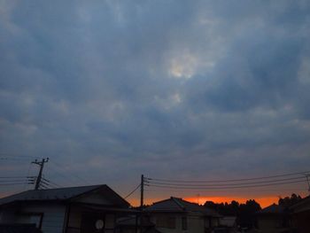 Low angle view of silhouette buildings against sky