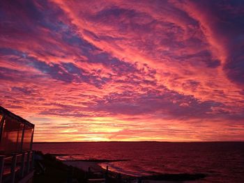 Scenic view of sea against orange sky