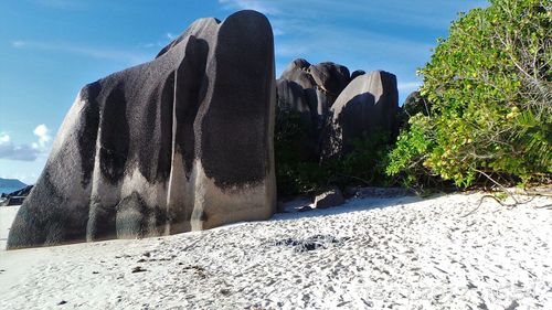 Panoramic shot of rocks on beach against sky