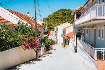 Footpath amidst buildings against sky