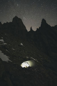 Scenic view of snowcapped mountains against sky at night