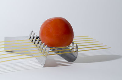 Close-up of bread on table against white background