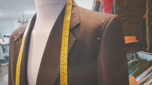 Close-up of suit with measure tape on mannequin
