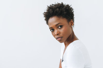 Portrait of beautiful young african american woman in white t-shirt isolated on white background