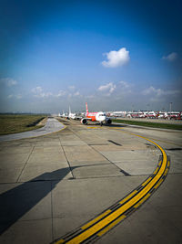 Airplane on road against sky