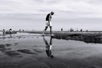 Woman jumping on shore