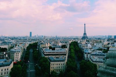 Eiffel tower with cityscape against sky