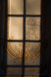 Sunset light through a window, sun reflection on a wall and interior decor, background, copy space