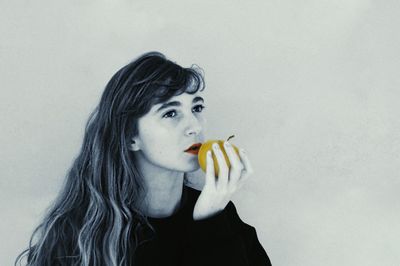 Portrait of young woman against white background