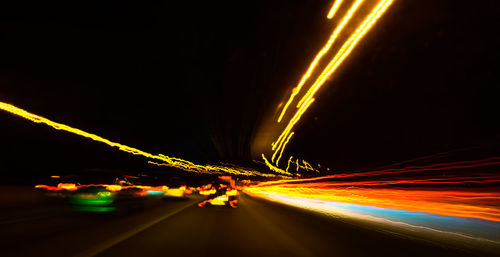 Light trails on road in tunnel at night