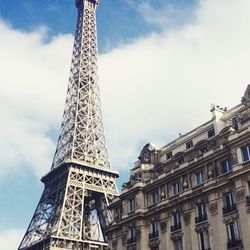 Low angle view of eiffel tower against clouds