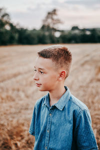 Portrait of boy standing on land