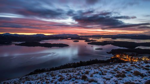 Sunrise on a cloudy, winter morning over the village of luss and loch lomond scotland.