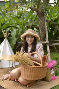 Portrait of smiling woman sitting in basket