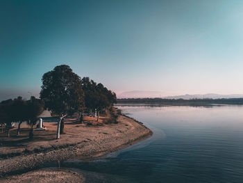 Scenic view of lake against clear blue sky