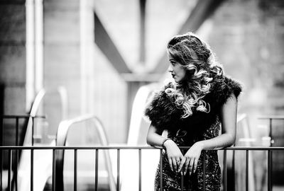 Woman standing by railing