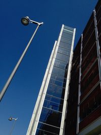 Low angle view of street light against blue sky