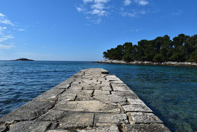 Scenic view of sea against blue sky