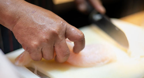 Close-up of man preparing food