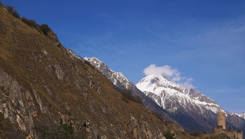 Scenic view of mountains against cloudy sky