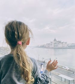 Rear view of woman with buildings in background
