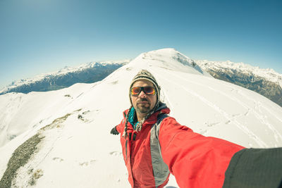 High angle view of person on snowcapped mountain against clear sky