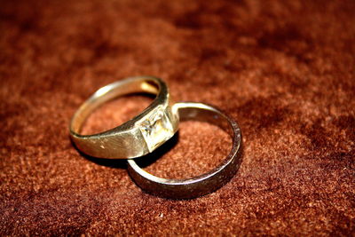 Close-up of wedding rings on table